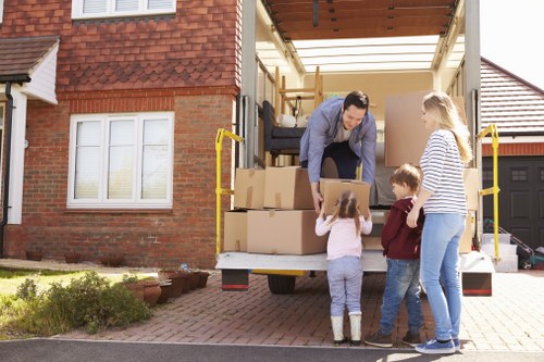 Professional movers placing office furniture and equipment into a new Bayswater workspace