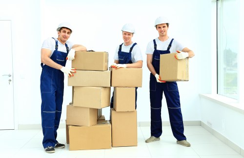 Removal workers carrying furniture through a Bayswater staircase