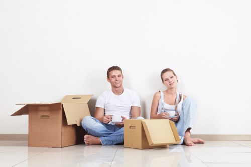 Packed moving boxes and furniture prepared for a Bayswater flat relocation