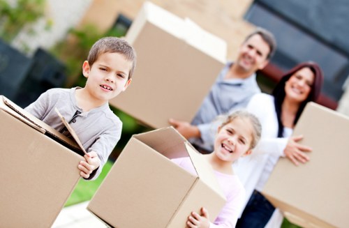 Local movers carrying household items through a Bayswater property entrance