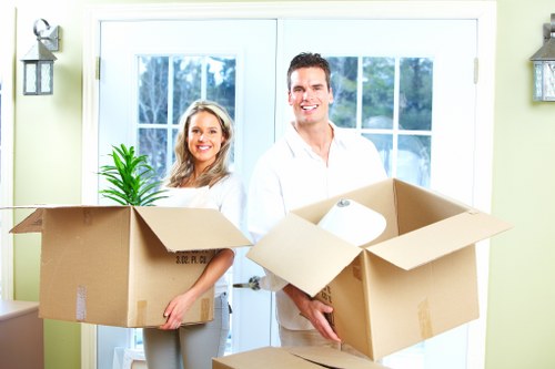 Movers handling desks and furniture during a local office relocation